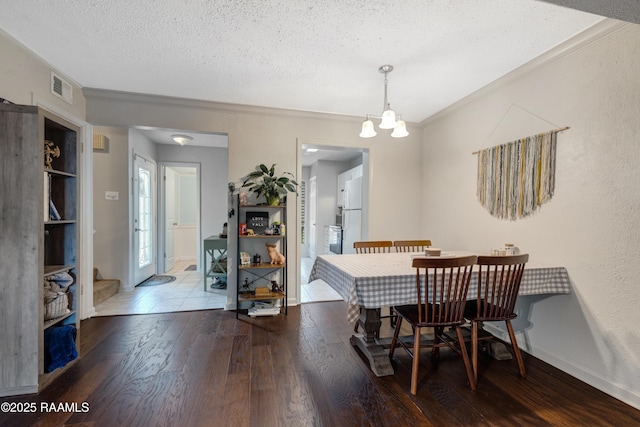 26 Morning Glory Sq, Lafayette, LA 70507 - dining room featuring wood finished floors, a textured ceiling, a chandelier, and ornamental molding