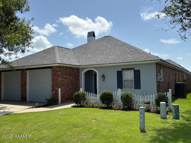 101 Asphodel Ct, Lafayette, LA 70503 - view of front of house with an attached garage, a shingled roof, driveway, and a chimney