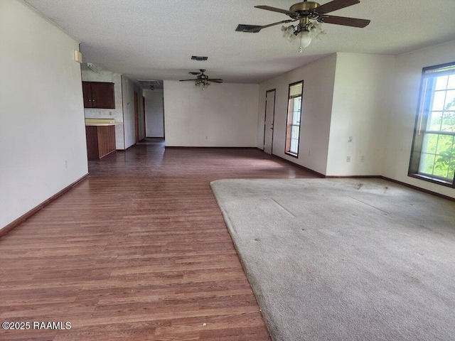 4702 Daspit Rd, New Iberia, LA 70563 - empty room with a ceiling fan, dark wood-type flooring, and a textured ceiling