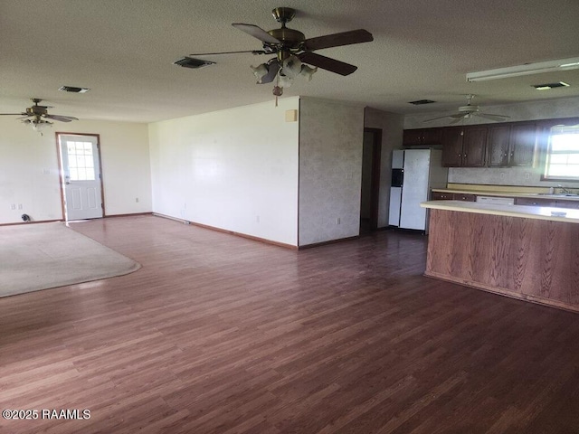 4702 Daspit Rd, New Iberia, LA 70563 - unfurnished living room with ceiling fan, dark wood finished floors, and plenty of natural light