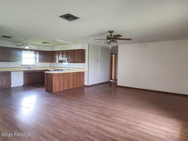 4702 Daspit Rd, New Iberia, LA 70563 - kitchen featuring ceiling fan, dishwasher, under cabinet range hood, dark wood-type flooring, and a textured ceiling