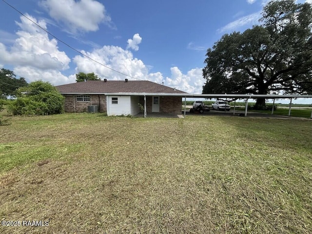 4702 Daspit Rd, New Iberia, LA 70563 - rear view of house featuring an attached carport and a lawn