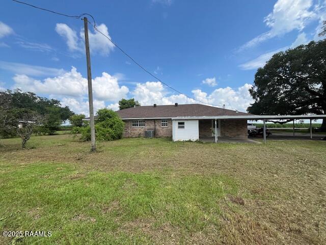 4702 Daspit Rd, New Iberia, LA 70563 - back of property featuring an attached carport and a yard