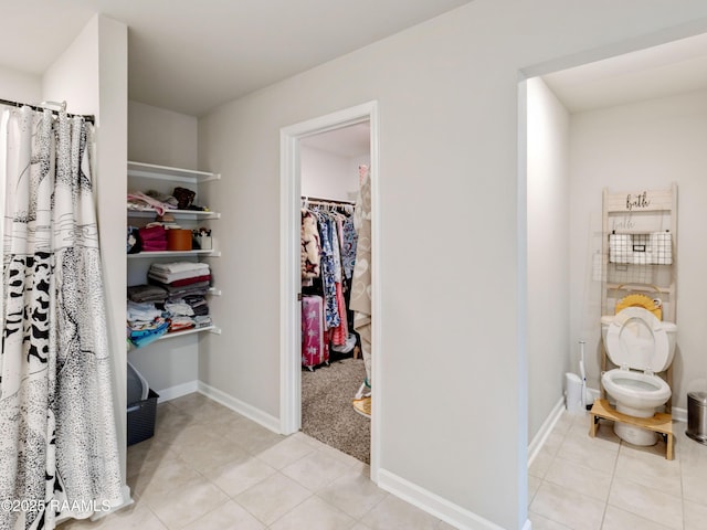 107 Southern Oak Dr, Lafayette, LA 70507 - bathroom with tile patterned flooring and a walk in closet
