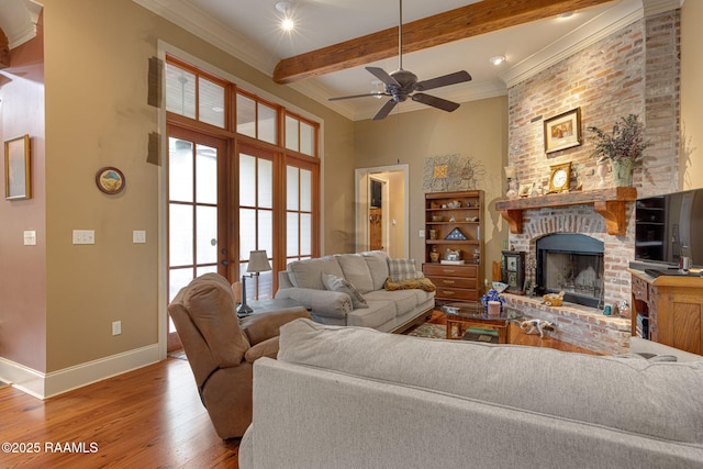 104 Littleton Xing, Lafayette, LA 70508 - living area featuring wood finished floors, a fireplace, ceiling fan, beamed ceiling, and crown molding