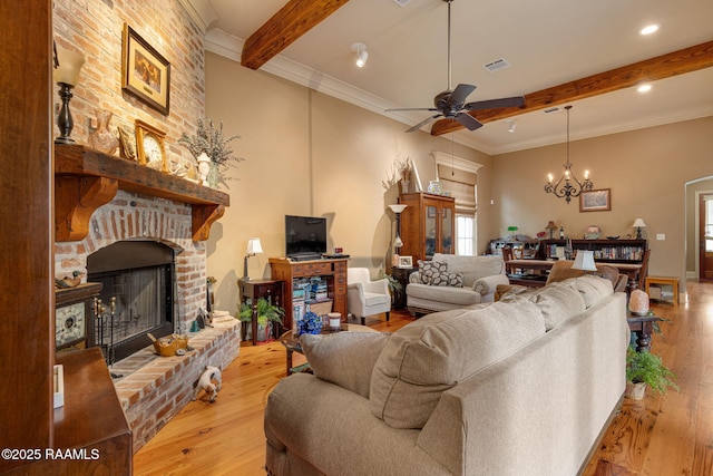 104 Littleton Xing, Lafayette, LA 70508 - living area with beam ceiling, a fireplace, a ceiling fan, light wood-type flooring, and a chandelier
