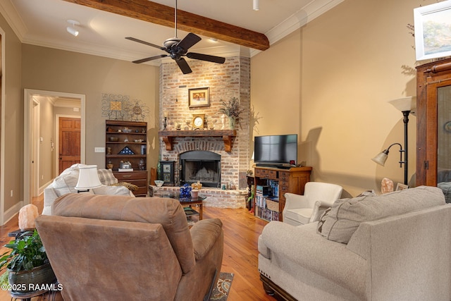 104 Littleton Xing, Lafayette, LA 70508 - living room featuring a brick fireplace, wood finished floors, a ceiling fan, beamed ceiling, and ornamental molding