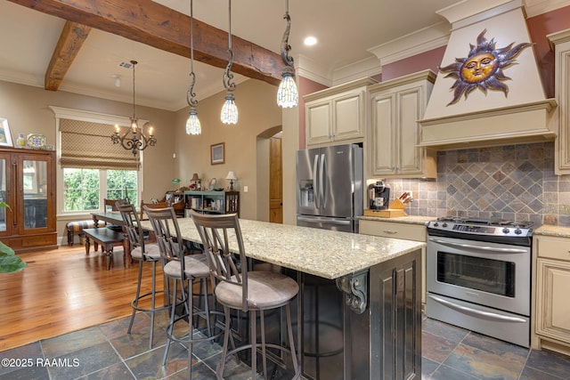 104 Littleton Xing, Lafayette, LA 70508 - kitchen with cream cabinetry, appliances with stainless steel finishes, crown molding, backsplash, and custom range hood