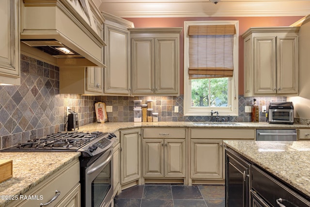 104 Littleton Xing, Lafayette, LA 70508 - kitchen with stainless steel appliances, cream cabinetry, custom exhaust hood, and ornamental molding