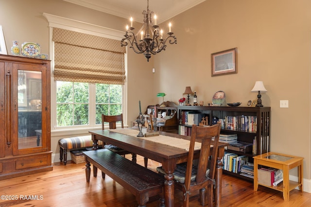104 Littleton Xing, Lafayette, LA 70508 - dining area with ornamental molding, a chandelier, and light wood finished floors