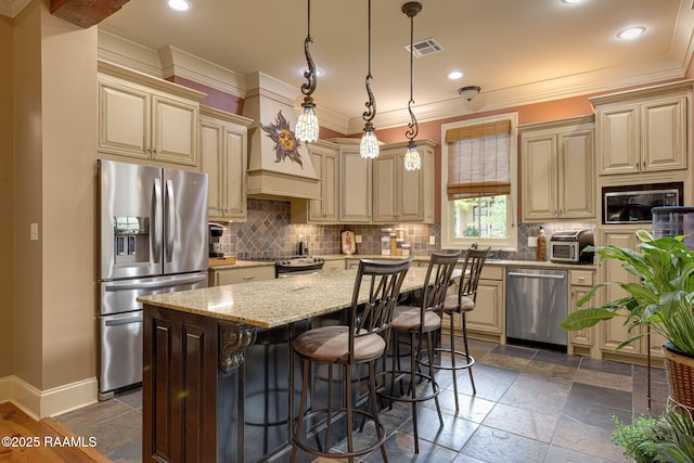 104 Littleton Xing, Lafayette, LA 70508 - kitchen with stainless steel appliances, cream cabinets, a kitchen island, backsplash, and recessed lighting