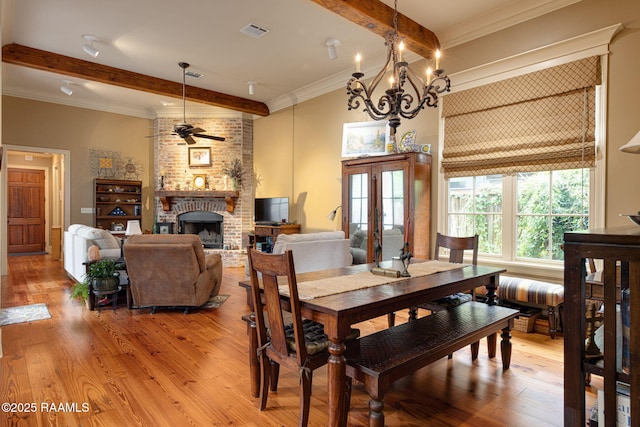 104 Littleton Xing, Lafayette, LA 70508 - dining space with beamed ceiling, ceiling fan, light wood-style floors, a brick fireplace, and ornamental molding