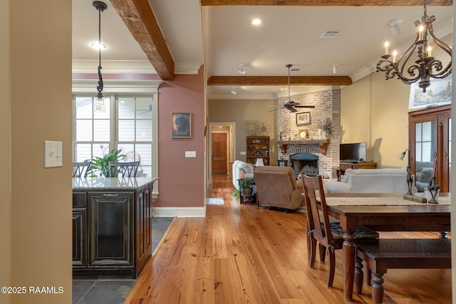 104 Littleton Xing, Lafayette, LA 70508 - dining area featuring crown molding, beamed ceiling, healthy amount of natural light, ceiling fan, and a brick fireplace