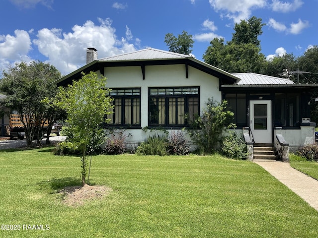 1510 Weems Ave, Lecompte, LA 71346 - view of front facade featuring a chimney, a front yard, and stucco siding