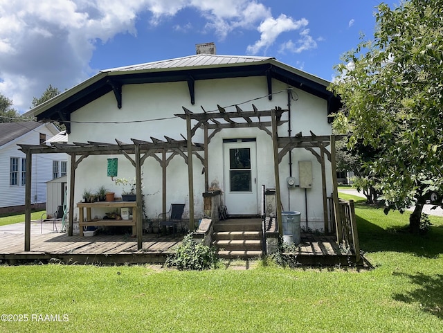 1510 Weems Ave, Lecompte, LA 71346 - rear view of property featuring a pergola, a wooden deck, a chimney, a yard, and stucco siding