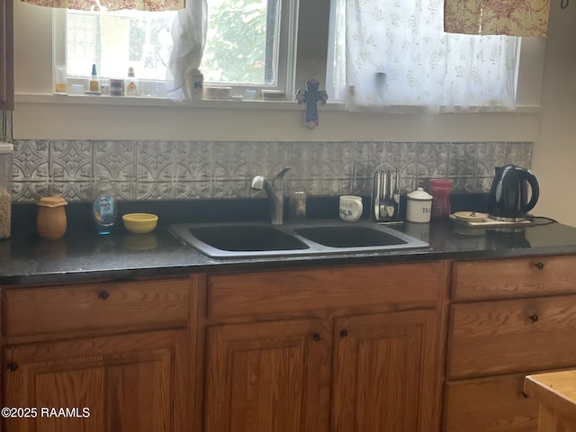 1510 Weems Ave, Lecompte, LA 71346 - kitchen featuring brown cabinetry, dark countertops, and decorative backsplash