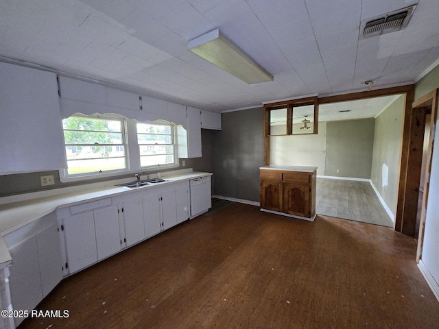 110 Judge Dr, Lafayette, LA 70507 - kitchen with dishwasher, dark wood finished floors, white cabinets, and light countertops