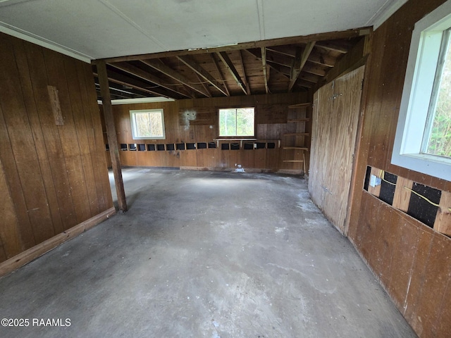 110 Judge Dr, Lafayette, LA 70507 - misc room featuring wooden walls, concrete flooring, and healthy amount of natural light