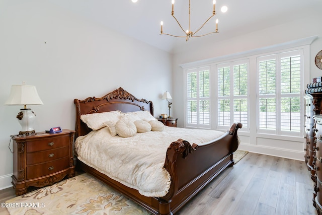 604 Channel Dr, Broussard, LA 70518 - bedroom with wood finished floors and a chandelier