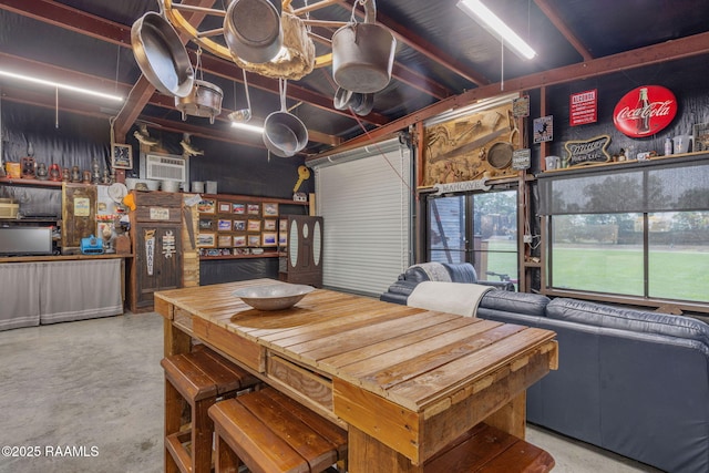 1054 Preston Broussard Rd, Arnaudville, LA 70512 - dining area featuring finished concrete floors and a wall unit AC