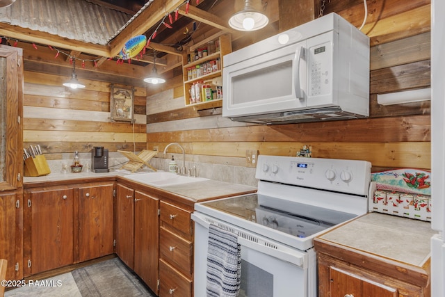 1054 Preston Broussard Rd, Arnaudville, LA 70512 - kitchen featuring white appliances, wooden walls, light countertops, and brown cabinetry
