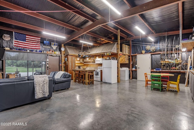1054 Preston Broussard Rd, Arnaudville, LA 70512 - basement featuring freestanding refrigerator, washer / dryer, and a workshop area