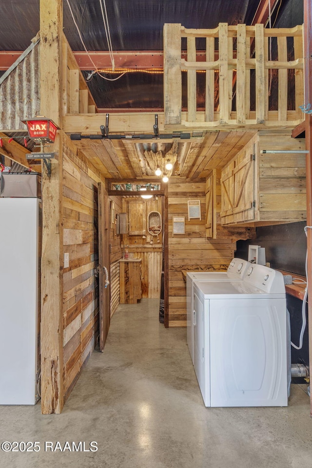 1054 Preston Broussard Rd, Arnaudville, LA 70512 - laundry area with wooden walls and separate washer and dryer