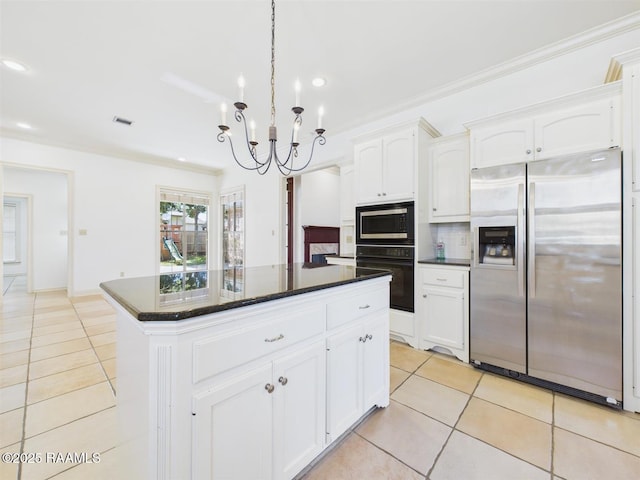 101 Lockeport Cir, Lafayette, LA 70508 - kitchen with appliances with stainless steel finishes, light tile patterned floors, a chandelier, backsplash, and white cabinetry