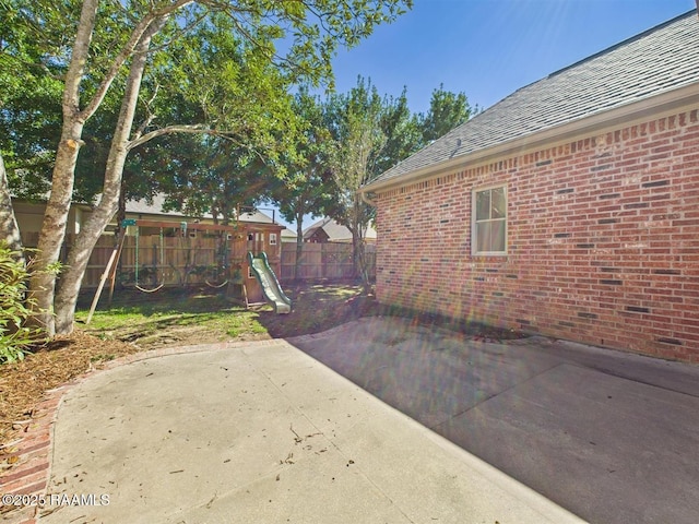 101 Lockeport Cir, Lafayette, LA 70508 - fenced backyard featuring a playground and a patio area