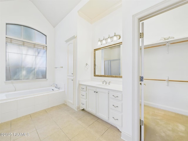 101 Lockeport Cir, Lafayette, LA 70508 - bathroom with vanity, a bath, vaulted ceiling, a walk in closet, and tile patterned flooring
