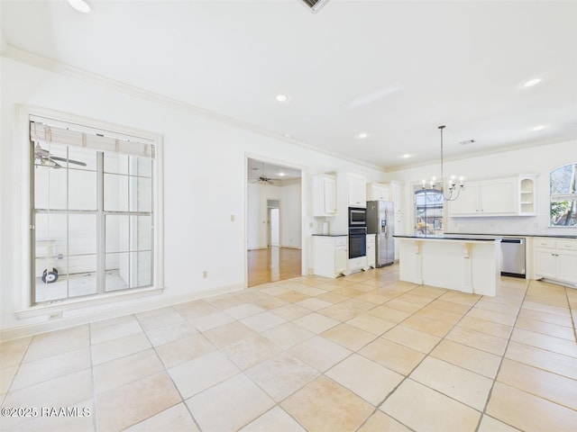 101 Lockeport Cir, Lafayette, LA 70508 - kitchen featuring appliances with stainless steel finishes, ornamental molding, a ceiling fan, light tile patterned flooring, and white cabinets