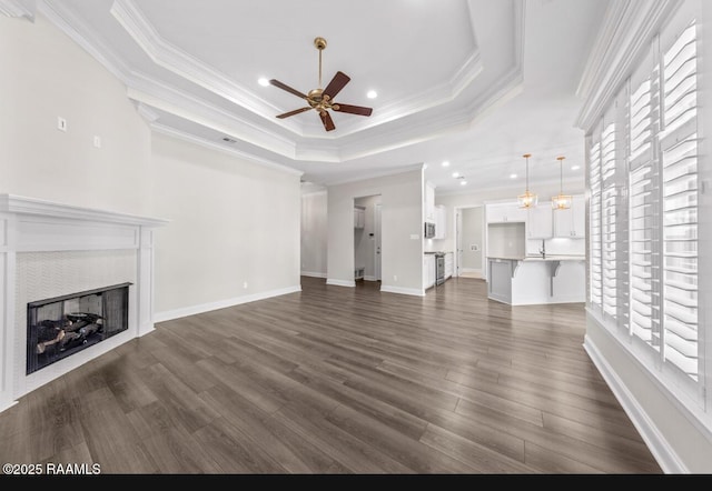 413 Easy Rock Landing Dr, Broussard, LA 70518 - unfurnished living room featuring ceiling fan, healthy amount of natural light, ornamental molding, a fireplace, and dark wood-type flooring