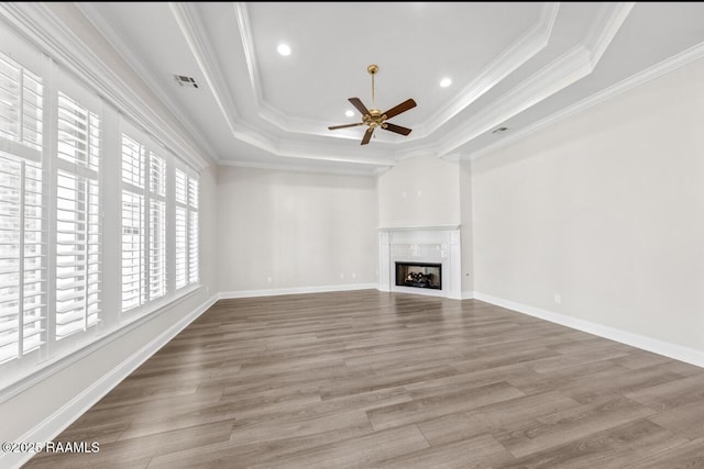 413 Easy Rock Landing Dr, Broussard, LA 70518 - unfurnished living room with a raised ceiling, a ceiling fan, a fireplace, crown molding, and wood finished floors