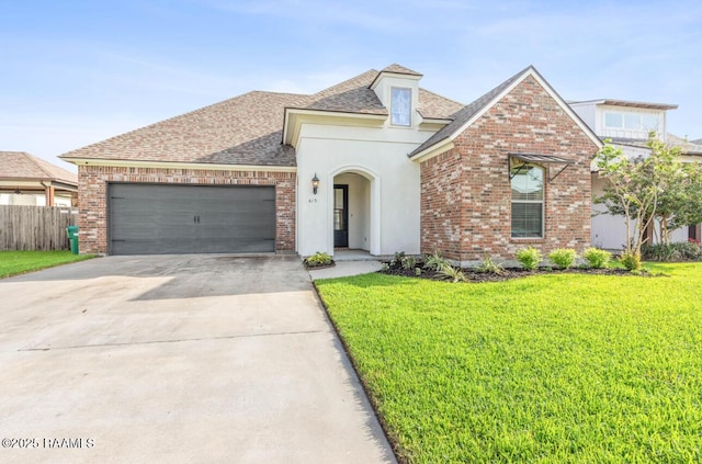 413 Easy Rock Landing Dr, Broussard, LA 70518 - french provincial home with an attached garage, a shingled roof, stucco siding, driveway, and brick siding