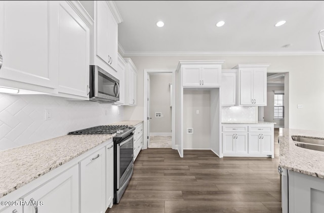 413 Easy Rock Landing Dr, Broussard, LA 70518 - kitchen with appliances with stainless steel finishes, crown molding, white cabinetry, decorative backsplash, and dark wood-style flooring