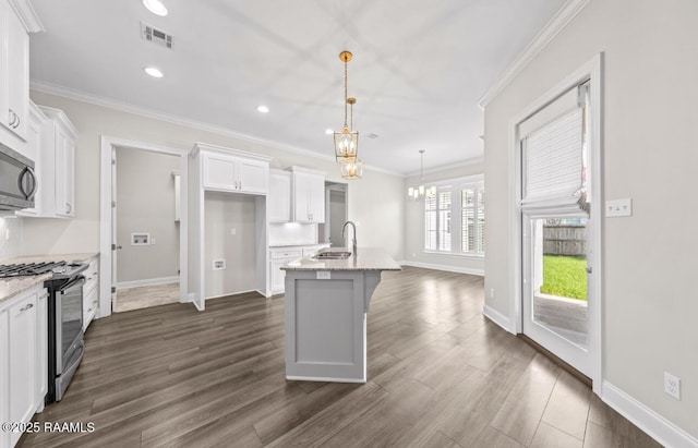 413 Easy Rock Landing Dr, Broussard, LA 70518 - kitchen with stainless steel appliances, a chandelier, white cabinets, dark wood-style flooring, and a kitchen island with sink