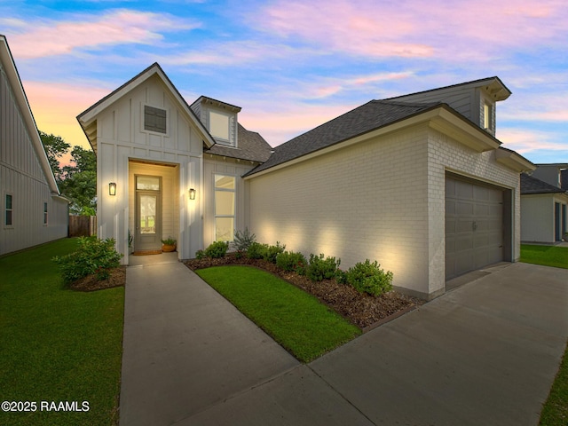 207 Timber Mill St, Lafayette, LA 70508 - view of front of house featuring an attached garage, concrete driveway, brick siding, a front yard, and board and batten siding