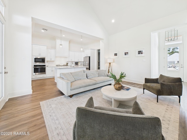 207 Timber Mill St, Lafayette, LA 70508 - living room with high vaulted ceiling, light wood-type flooring, and recessed lighting