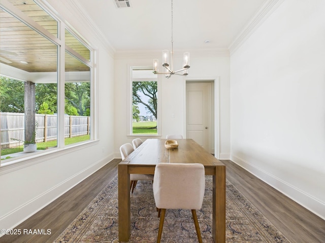 207 Timber Mill St, Lafayette, LA 70508 - dining room with plenty of natural light, a chandelier, dark wood finished floors, and ornamental molding