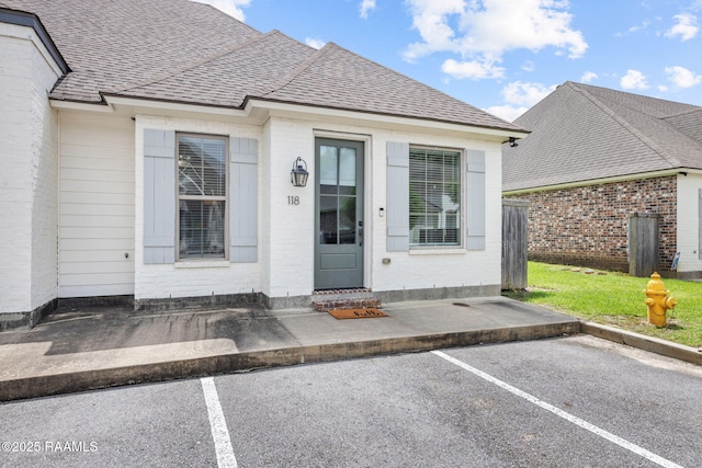 118 Rue Argenteuil, Lafayette, LA 70506 - entrance to property with a shingled roof, uncovered parking, and brick siding