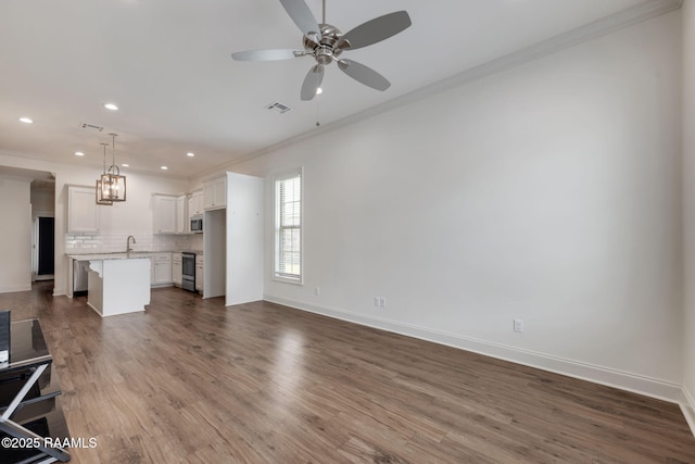 118 Rue Argenteuil, Lafayette, LA 70506 - unfurnished living room with ornamental molding, a ceiling fan, recessed lighting, and dark wood-style floors