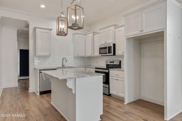 118 Rue Argenteuil, Lafayette, LA 70506 - kitchen featuring appliances with stainless steel finishes, white cabinetry, backsplash, crown molding, and recessed lighting