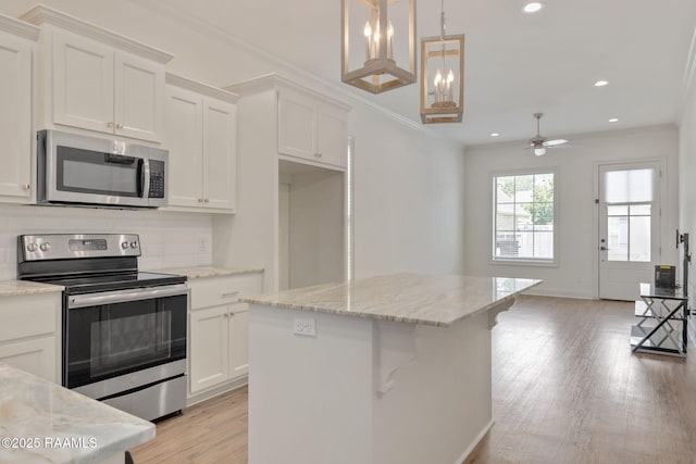 118 Rue Argenteuil, Lafayette, LA 70506 - kitchen with stainless steel appliances, light wood finished floors, white cabinetry, recessed lighting, and a ceiling fan