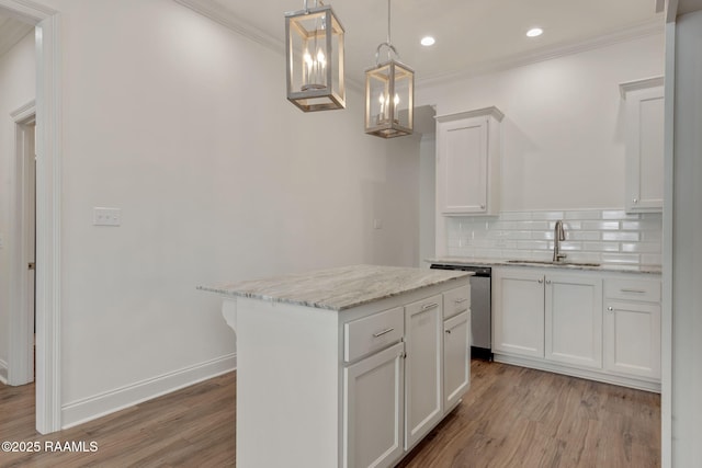118 Rue Argenteuil, Lafayette, LA 70506 - kitchen featuring stainless steel dishwasher, ornamental molding, light wood-type flooring, white cabinetry, and backsplash