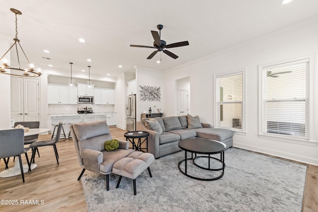 222 Alpine Dr, Lafayette, LA 70506 - living area with light wood-style flooring, ornamental molding, a chandelier, recessed lighting, and a ceiling fan