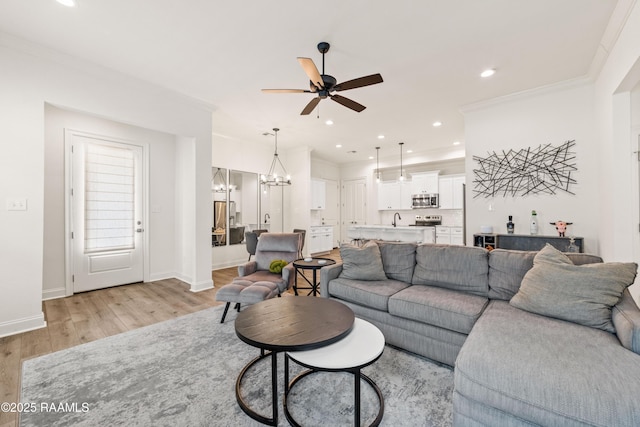 222 Alpine Dr, Lafayette, LA 70506 - living room with ceiling fan, light wood finished floors, a chandelier, recessed lighting, and ornamental molding