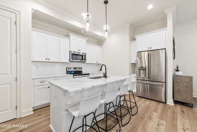 222 Alpine Dr, Lafayette, LA 70506 - kitchen with stainless steel appliances, ornamental molding, light wood-style flooring, backsplash, and white cabinets