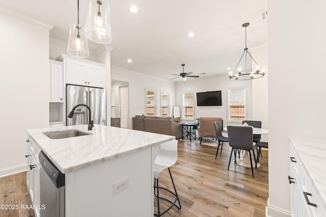 222 Alpine Dr, Lafayette, LA 70506 - kitchen featuring crown molding, appliances with stainless steel finishes, recessed lighting, white cabinets, and a center island with sink