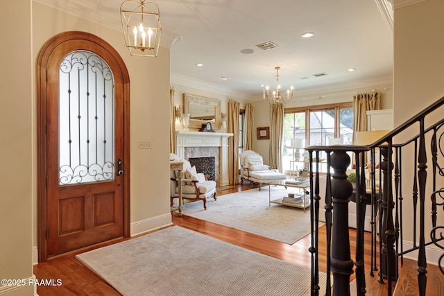 101 Enclave Ct, Lafayette, LA 70508 - entrance foyer featuring a chandelier, wood finished floors, crown molding, a high end fireplace, and recessed lighting