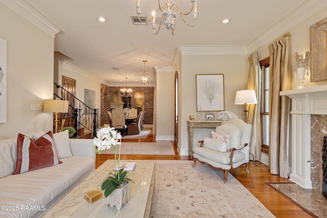 101 Enclave Ct, Lafayette, LA 70508 - living area with a chandelier, wood finished floors, stairs, ornamental molding, and a high end fireplace